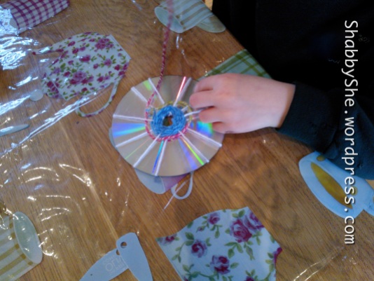 Use wool and recycled CDs to make artwork